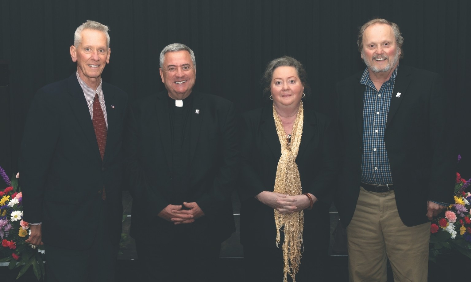 From left, Mark Biedlingmaier ’80, G’80, Rev. Joseph G. Marina, S.J., University president, Amy Biedlingmaier Brown and Paul Biedlingmaier Jr. ’76 gather for a photo at the 2025 Scholarship Brunch. 