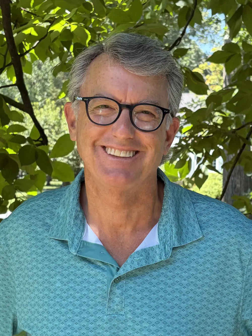Brian Loftus headshot with trees