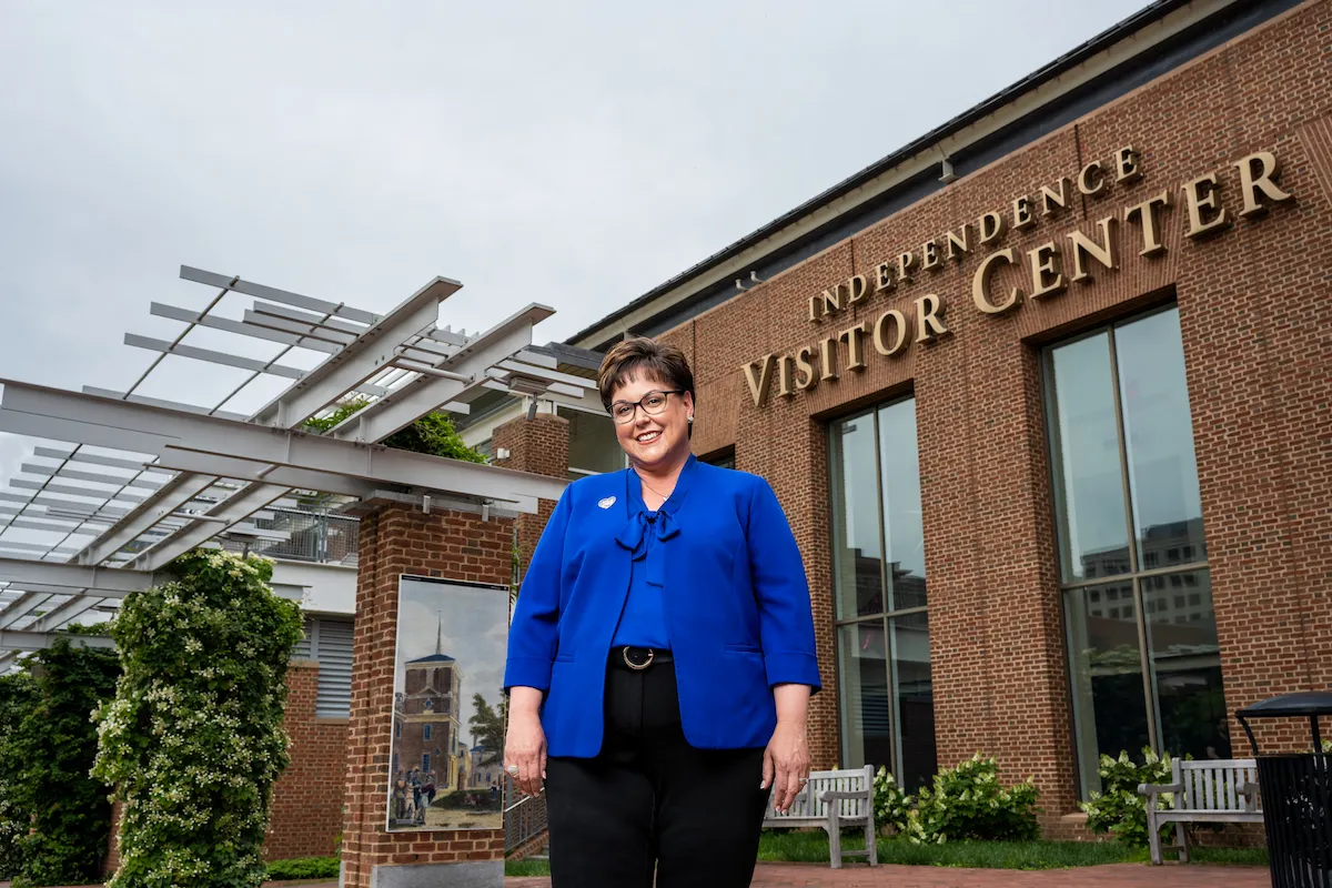 woman standing in front of brick building