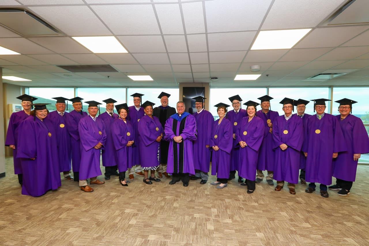 Shown above are members of the historic Class of 1976, including Pennington, at center, with Alumni Society President Christopher Neumann, Esq. ’87 and University President Rev. Joseph G. Marina, S.J.