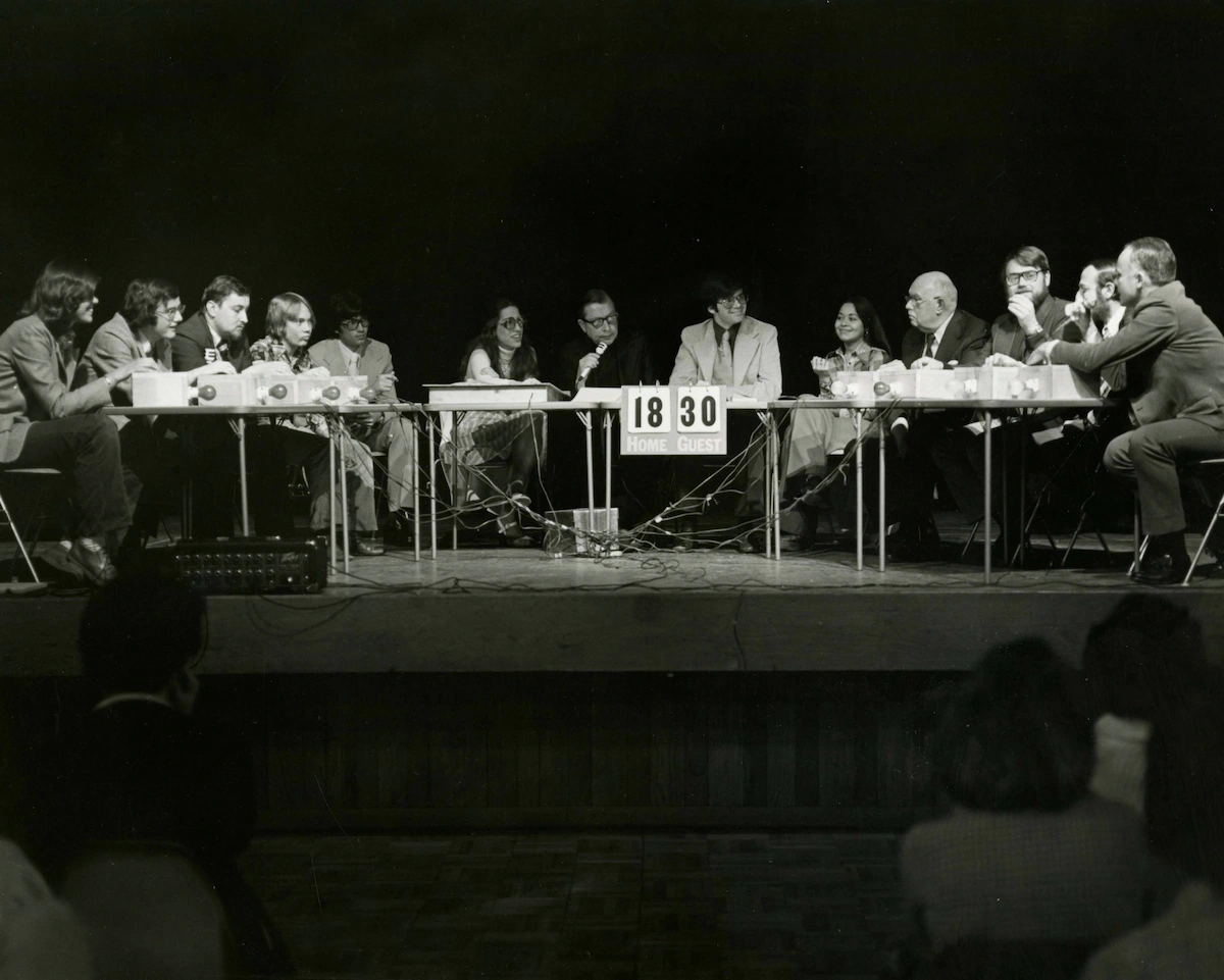 students and teacher sitting at tables